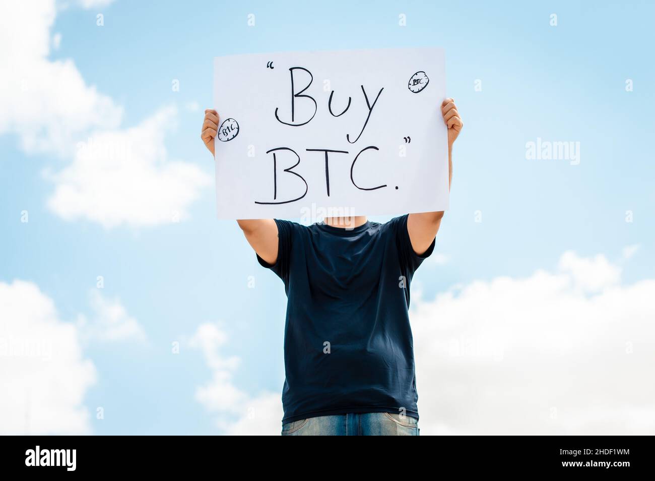 man with a sign that says buy bitcoin Stock Photo - Alamy