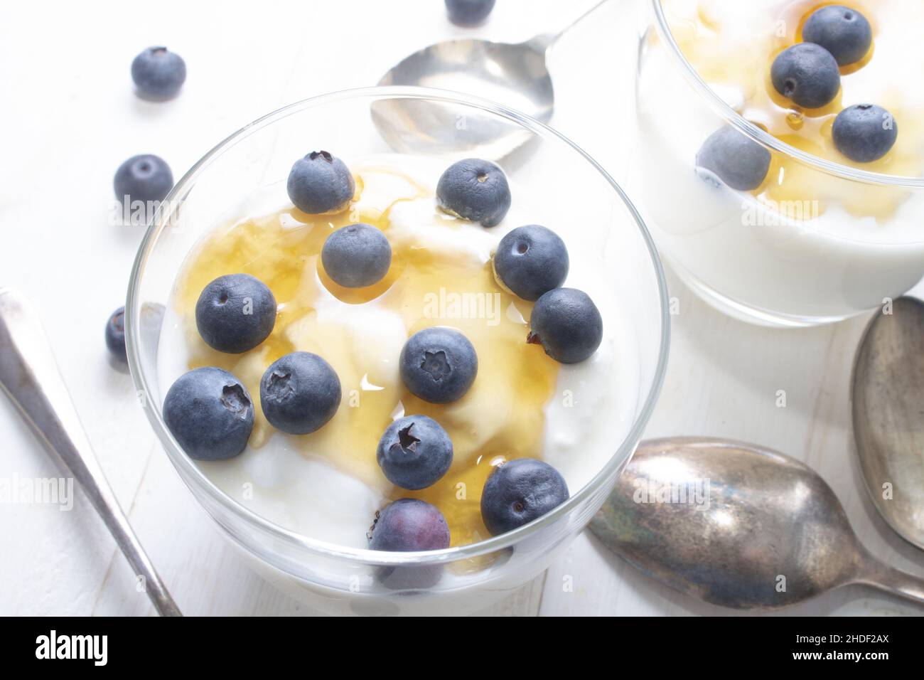 greek yogurt with sweet honey and some blueberries in a glass Stock Photo