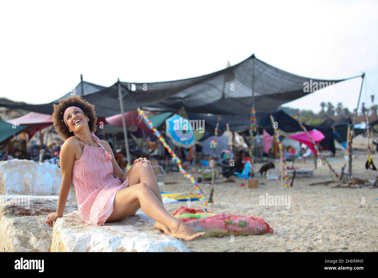 A 28 year old woman on the beach Festival tent in the background Stock Photo