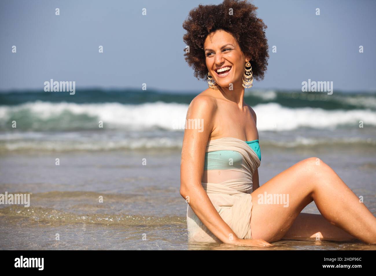 Happy excited 28 year old woman on the beach Stock Photo