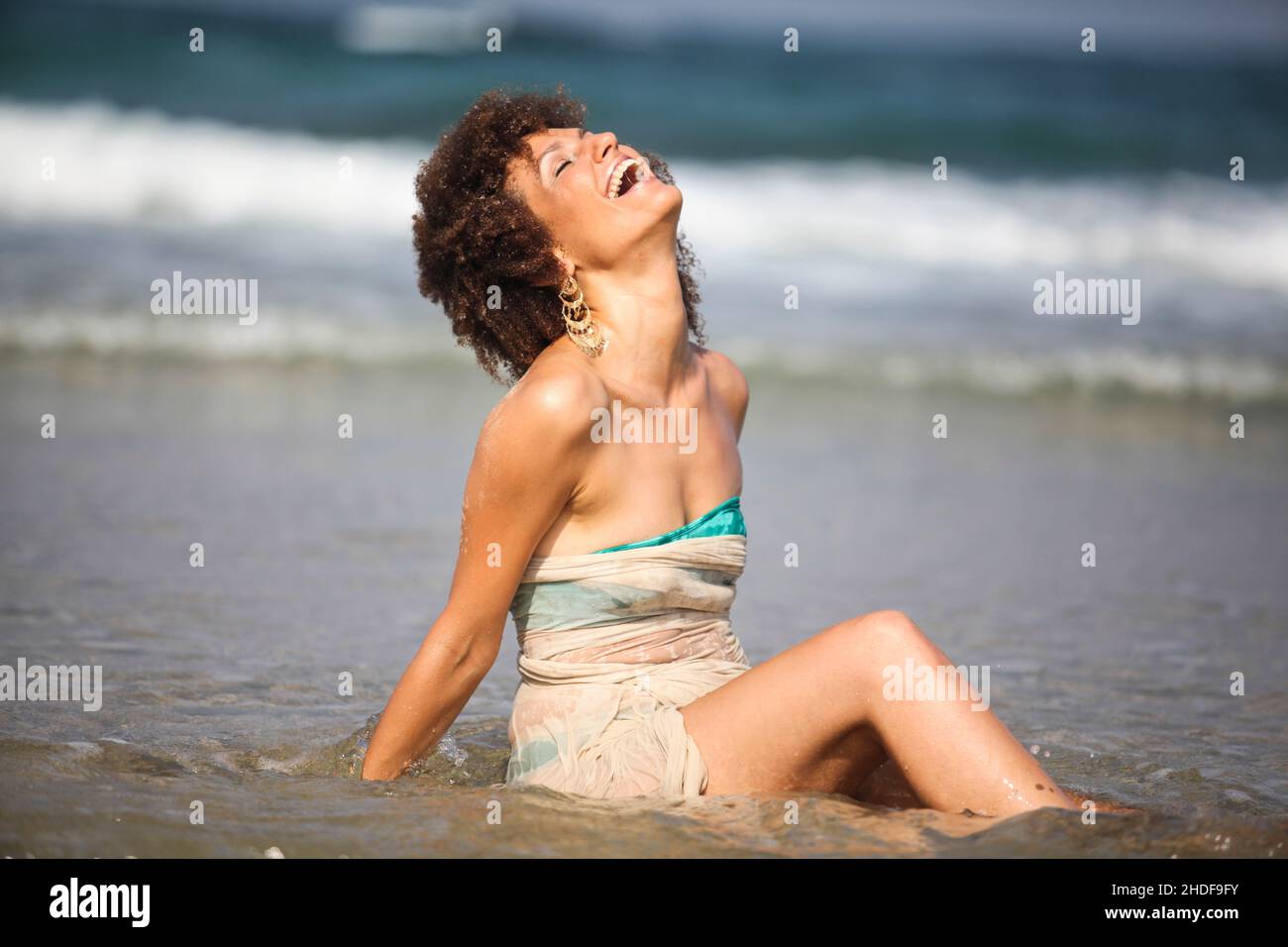 Happy excited 28 year old woman on the beach Stock Photo