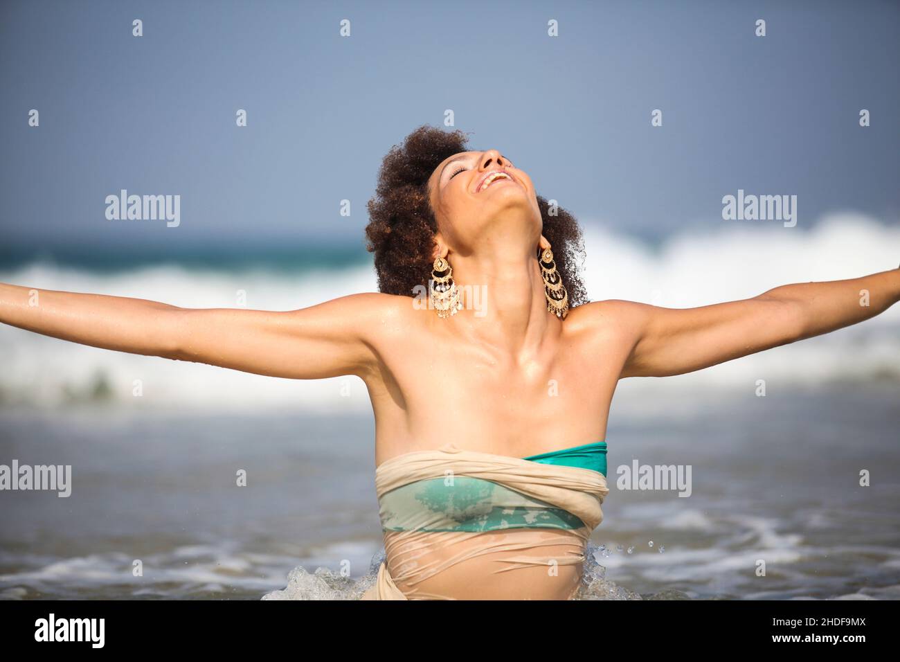 Happy excited 28 year old woman on the beach Stock Photo