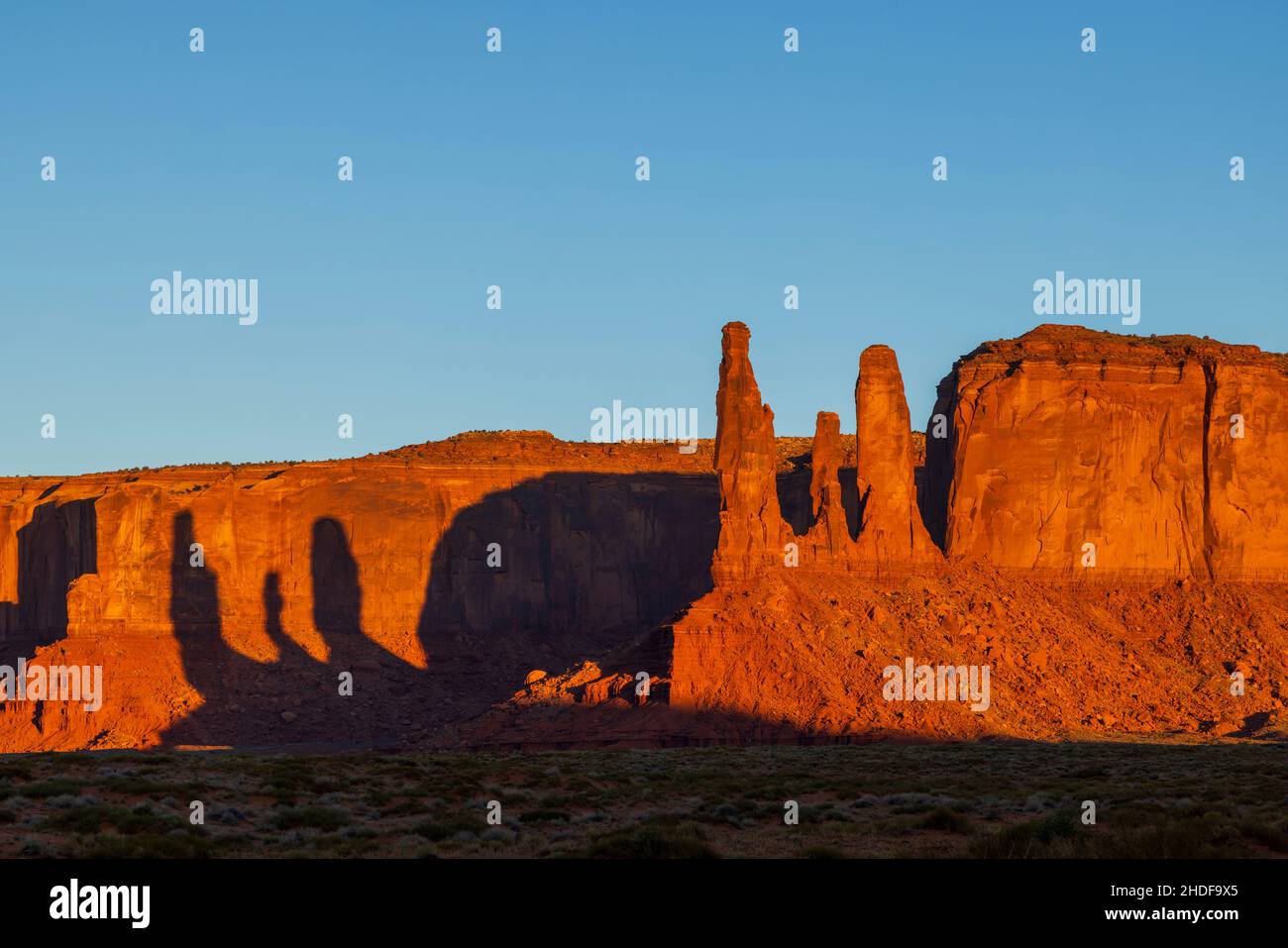 Three sisters rock formation at sunrise in Monument Valley Navajo Tribal Park, Utah Stock Photo