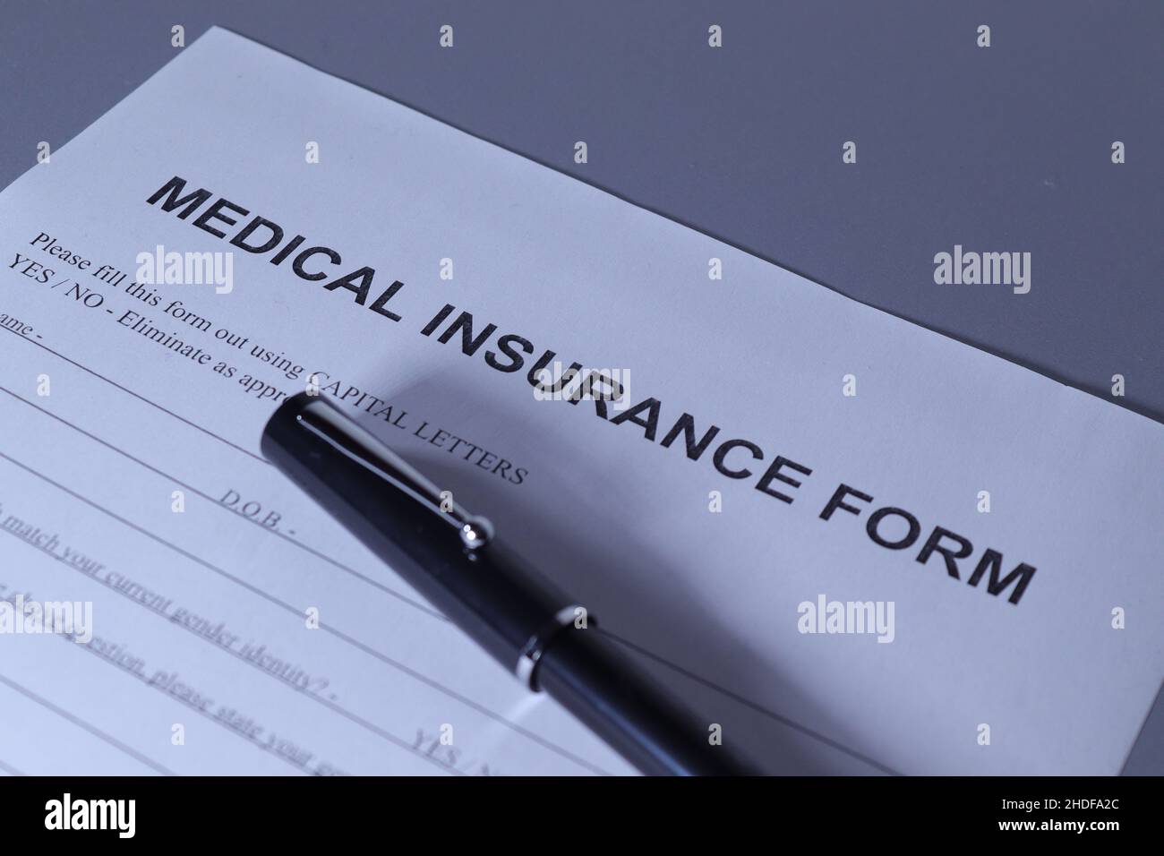 Medical Insurance Form with fountain pen lain across the top of the