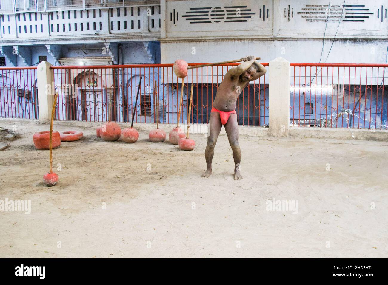 Unidentified Indian wrestlers do exercise by lifting their traditional equipments near ganga Ghat in Varanasi, Uttar Pradesh, India. Stock Photo