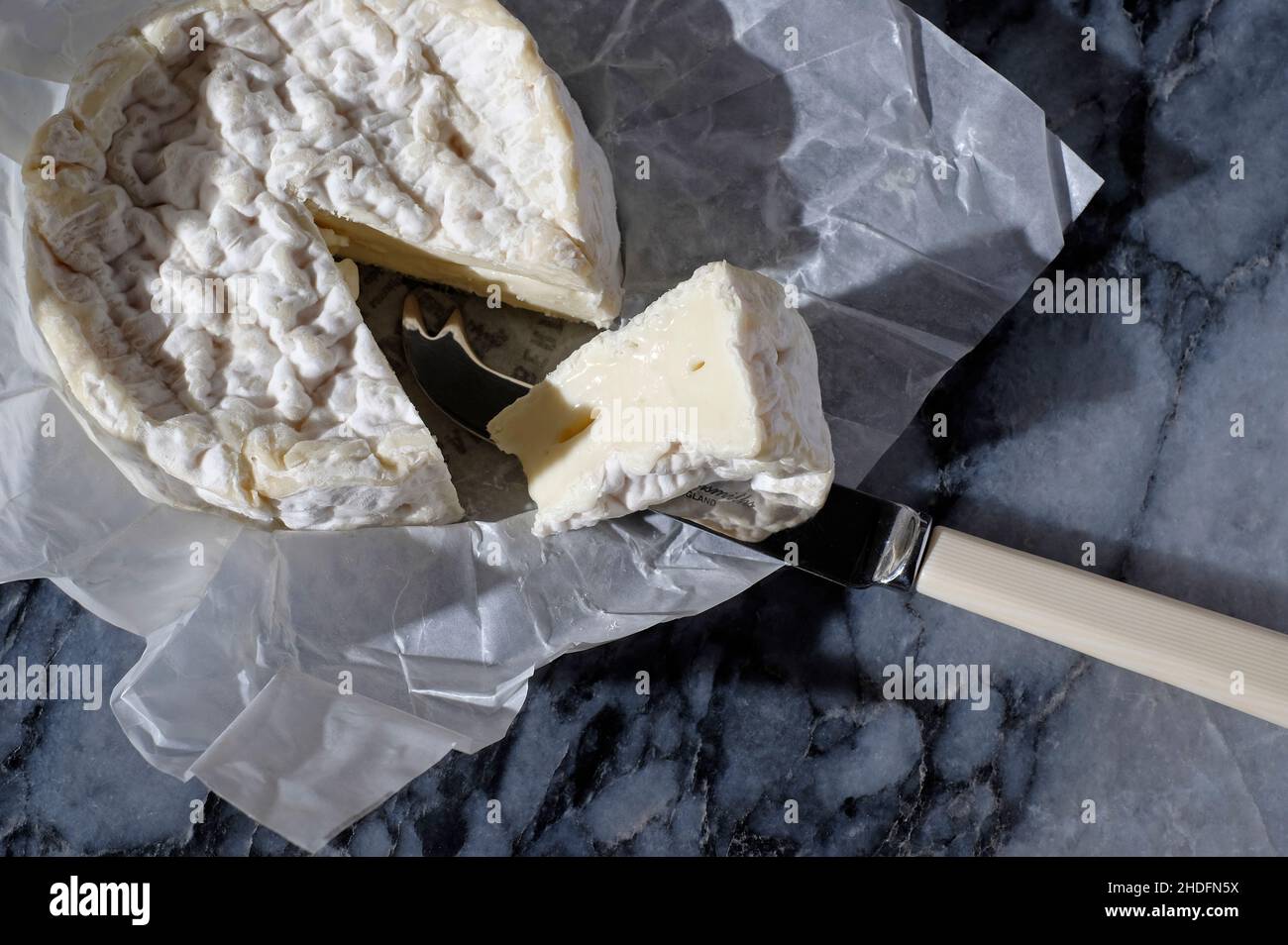 french camembert cheese on marble table top Stock Photo