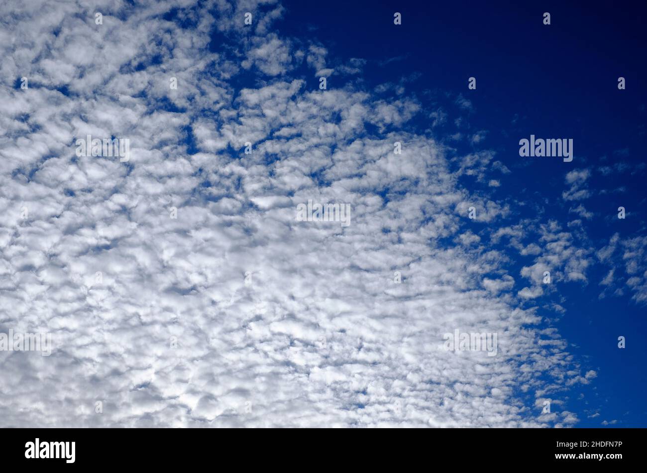 white fluffy clouds on blue sky background Stock Photo