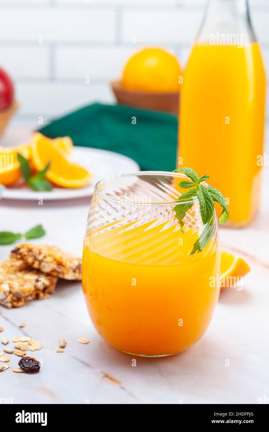 Closeup shot of a fresh juice with fruits in the background Stock Photo