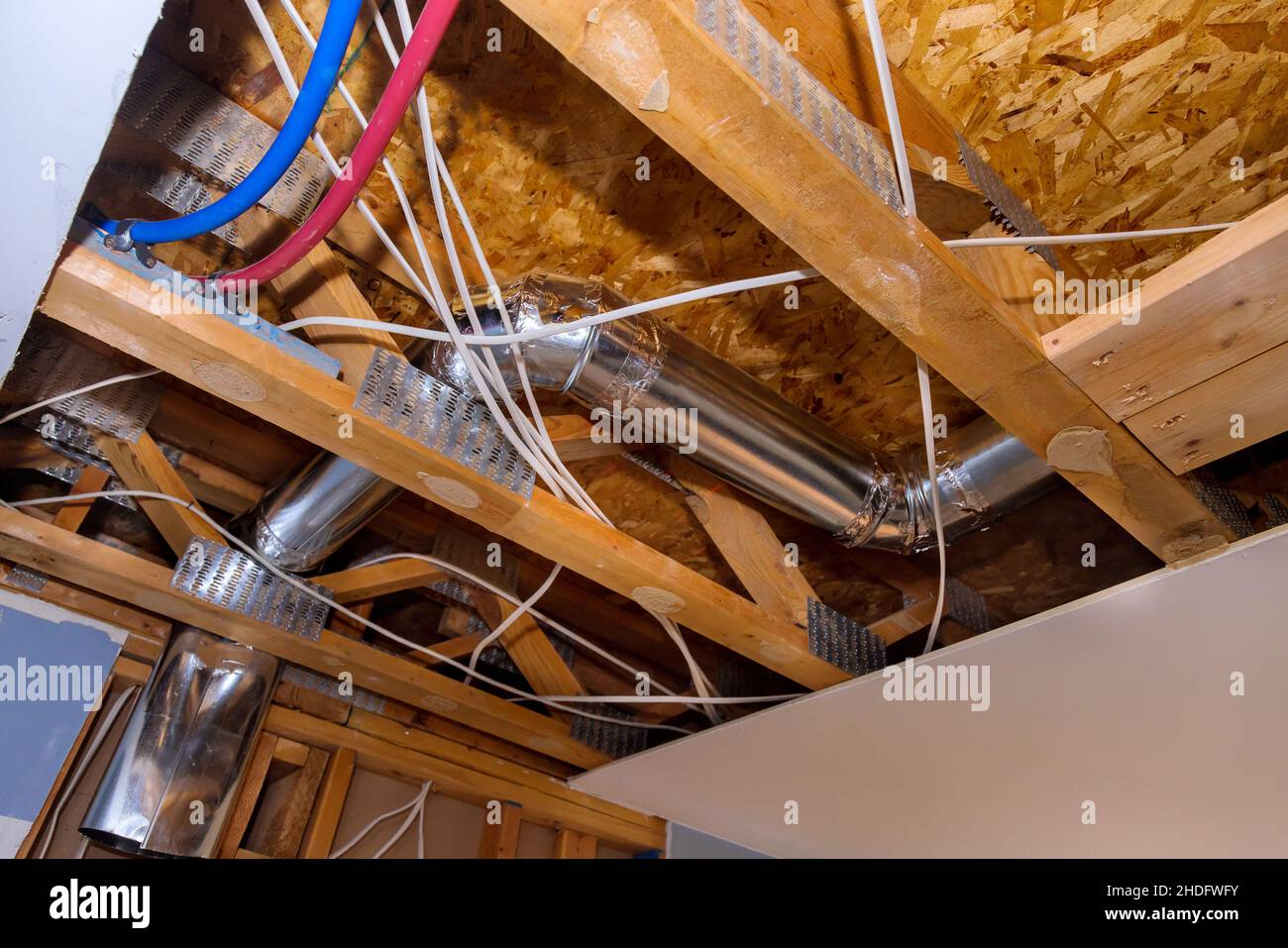 Ventilation pipe system in kitchen interior installation of ducts for heating system the ceiling mounted Stock Photo