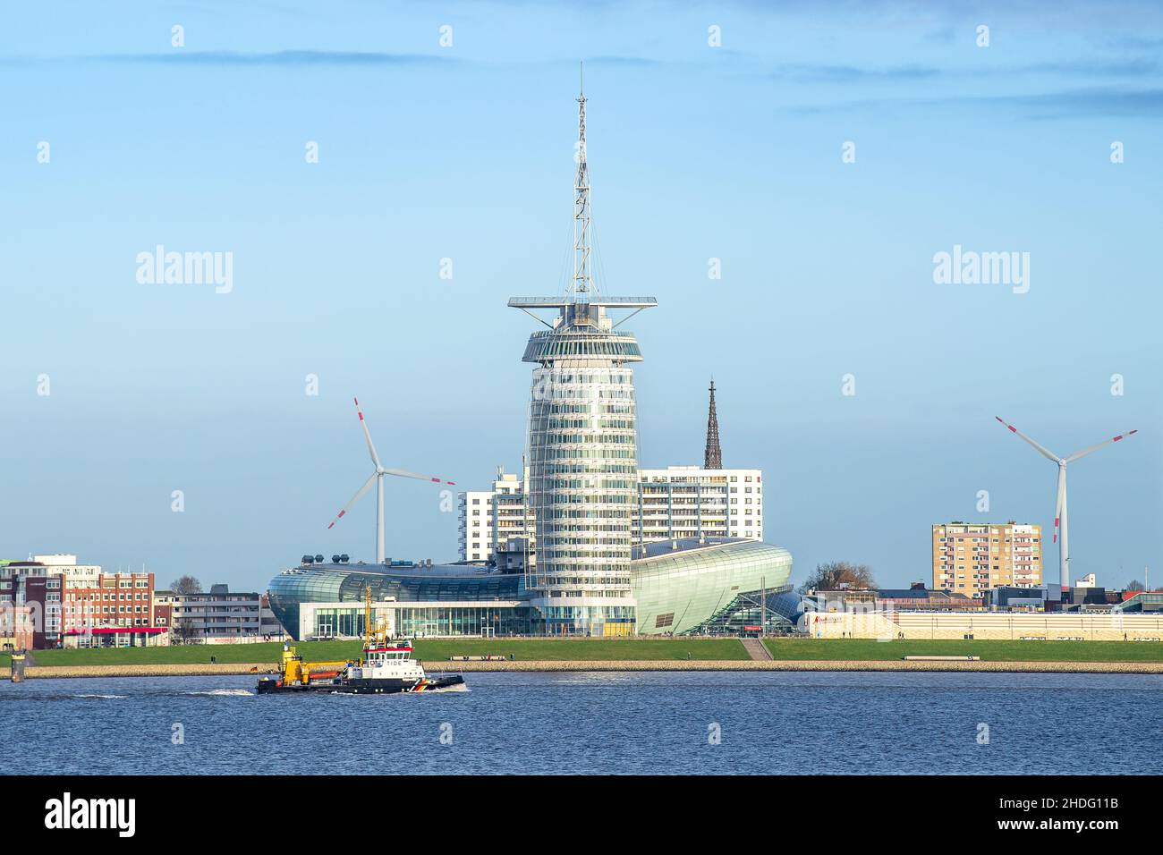 06 January 2022, Lower Saxony, Nordenham: A ship sails past the Klimahaus on the Weser. Photo: Sina Schuldt/dpa Stock Photo