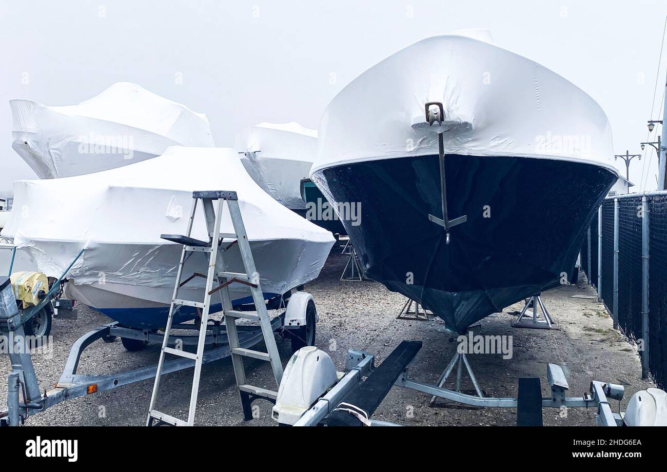 Boats on trailers wrapped up air tight and stored for the upcoming ...