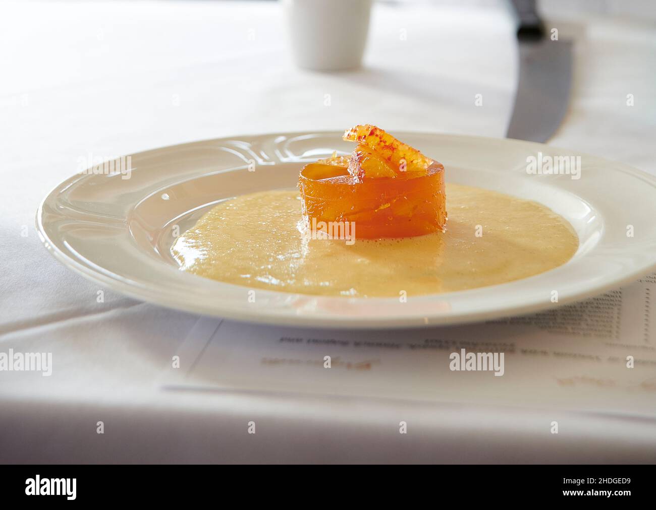 Blood Orange and whisky jelly with Crème anglaise, created by Michel Roux Jr, Stock Photo