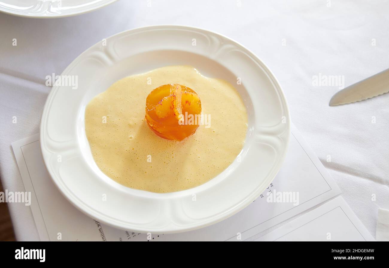 Blood Orange and whisky jelly with Crème anglaise, created by Michel Roux Jr, Stock Photo