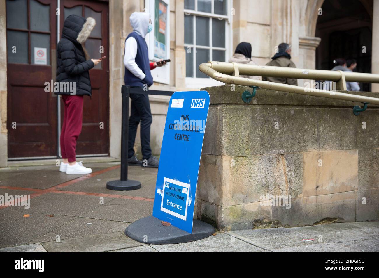 Members of the staff check people queuing outside a vaccination centre on Christmas Day in London as the Omicron variant reportedly spreads. Stock Photo