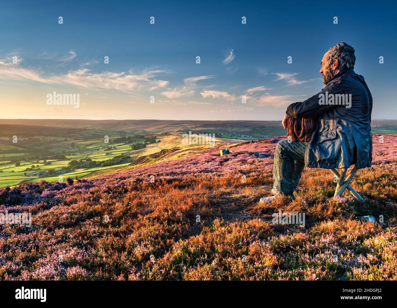 A controversial sculpture of 'The Seated Man' overlooking Westerdale on the North York moors. Stock Photo
