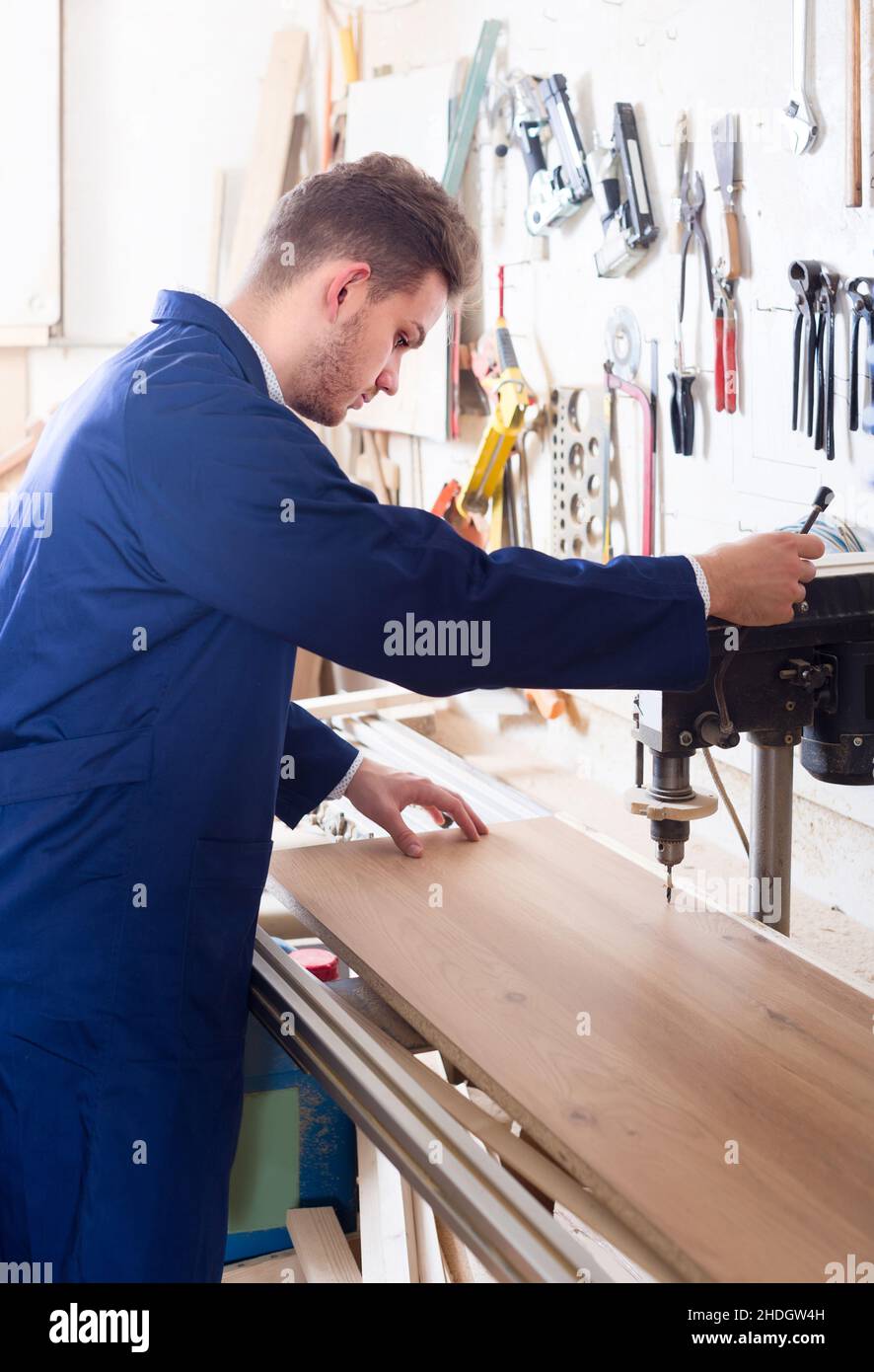 guy using drilling machine at workshop Stock Photo