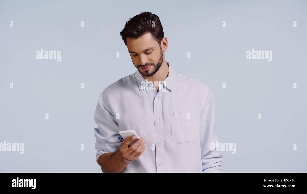 happy man using mobile phone isolated on blue Stock Photo - Alamy