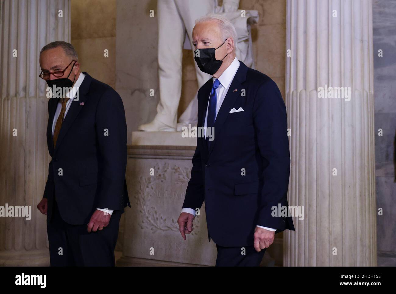 United States President Joe Biden is escorted by by US Senate Majority Leader Chuck Schumer (Democrat of New York) in the Hall of Columns as he arrives to mark the first anniversary of the January 6, 2021 attack on the U.S. Capitol by supporters of former President Donald Trump, on Capitol Hill in Washington, U.S., January 6, 2022.Credit: Evelyn Hockstein/Pool via CNP /MediaPunch Stock Photo