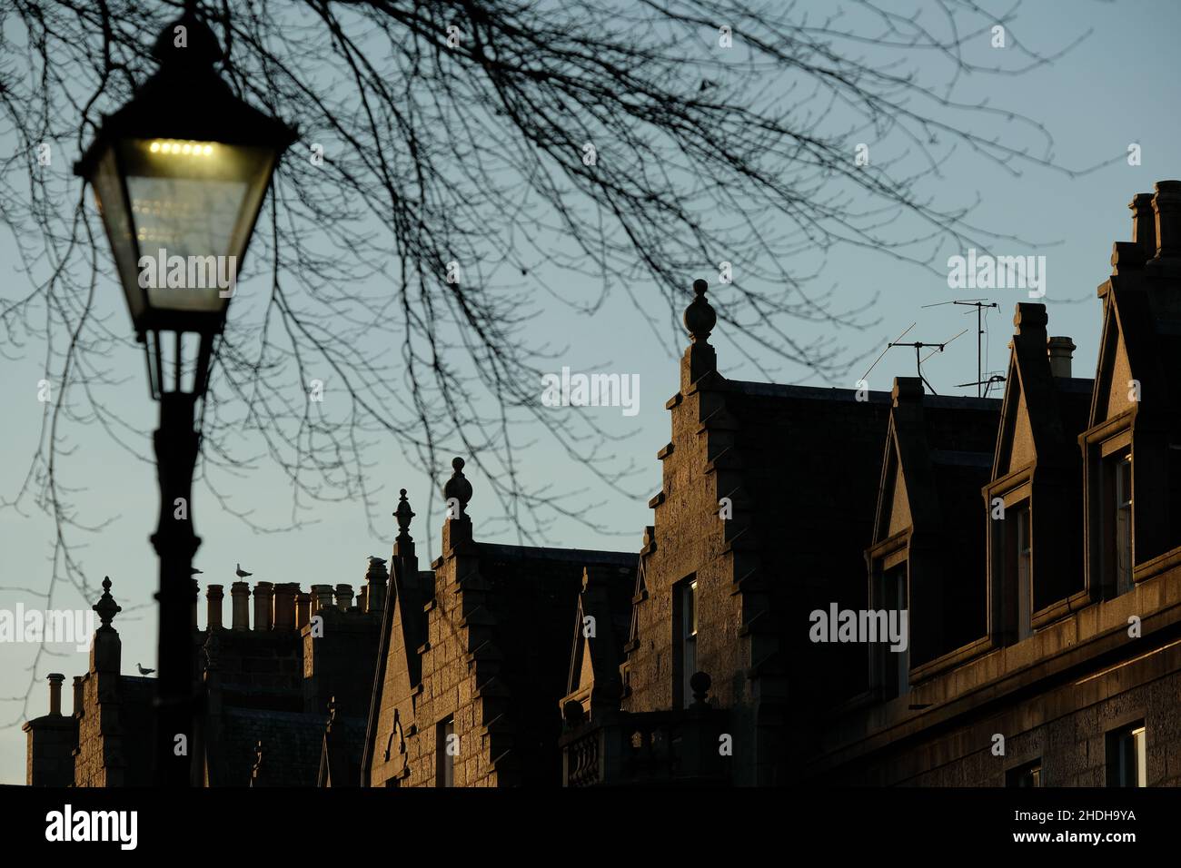 A colour photograph of the tops of buildings and a street lamp on Rubislaw Terrace, a popular conservation area, in Aberdeen, Scotland. Stock Photo