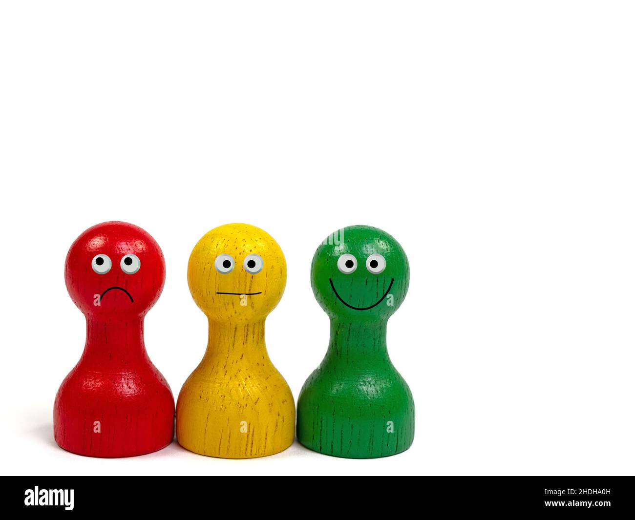 Three colorful wooden cones with faces Stock Photo