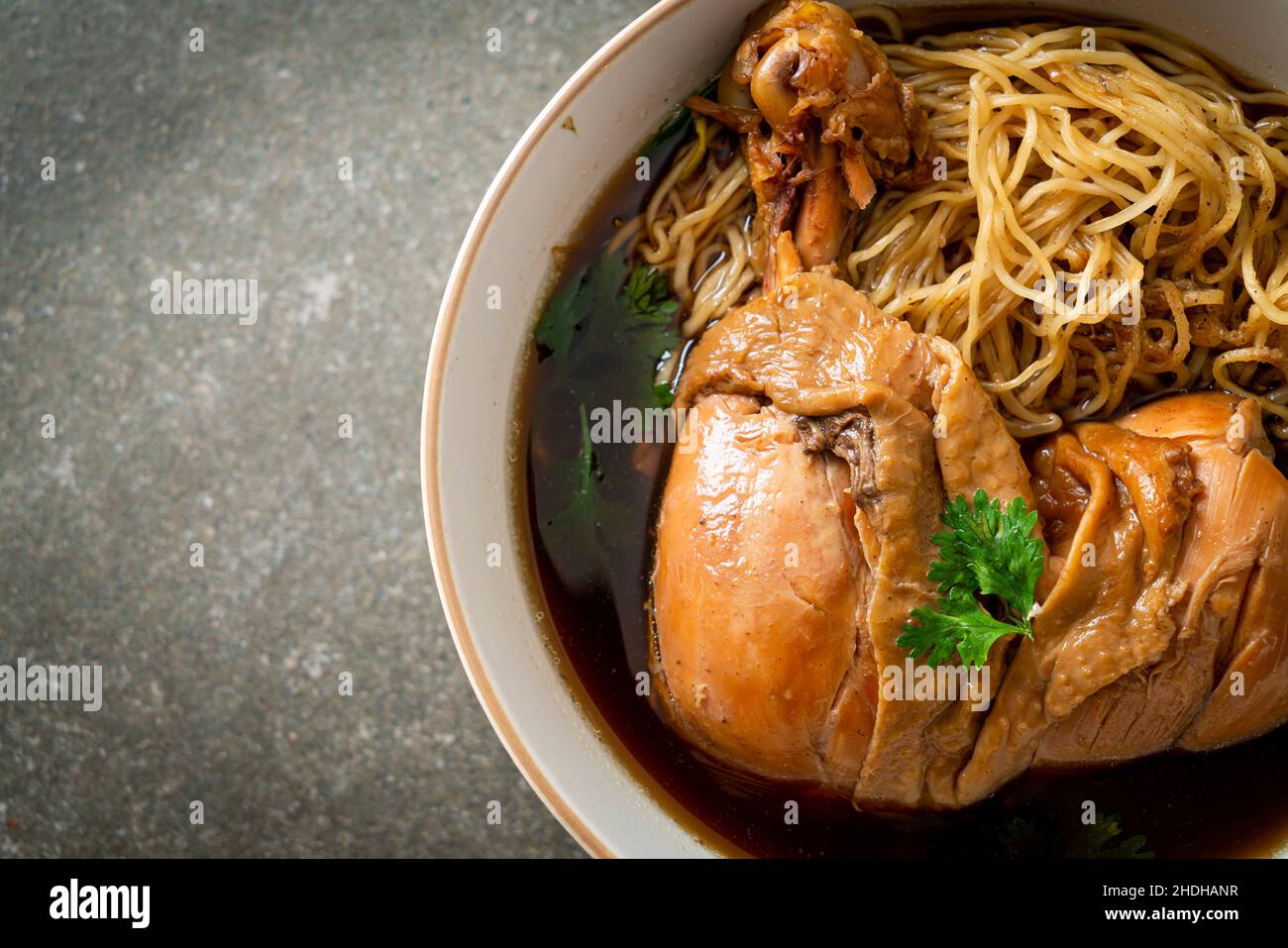 Noodles with Braised Chicken in Brown Soup Bowl - Asian food style Stock Photo