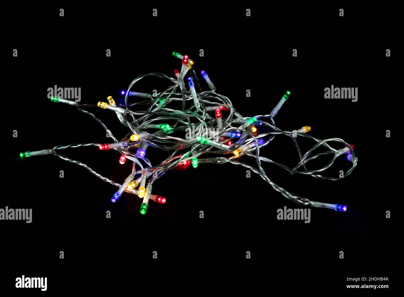 String of LED Christmas tree lights isolated on a black surface Stock Photo