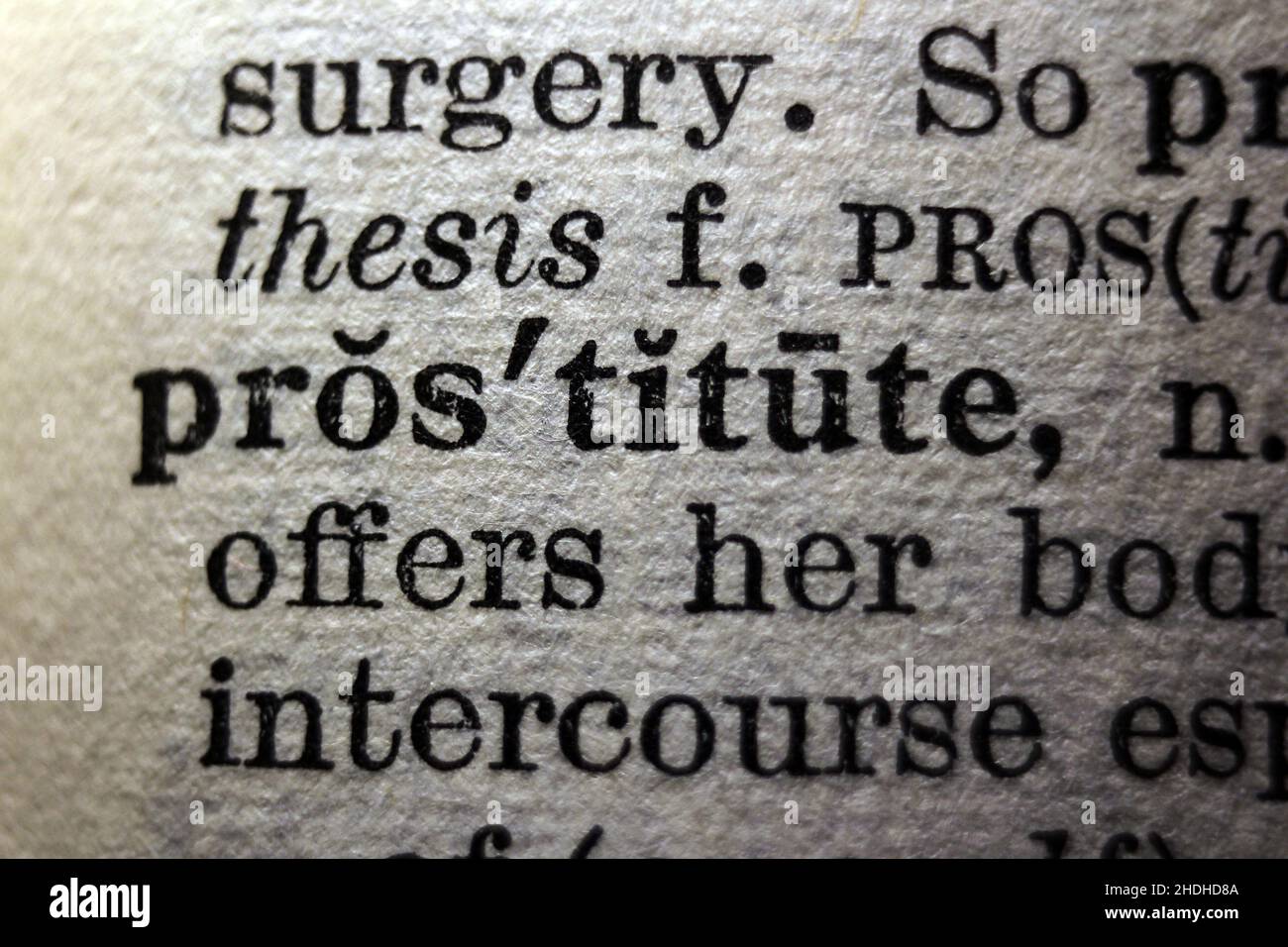 Word 'prostitute' printed on book page, macro close-up Stock Photo