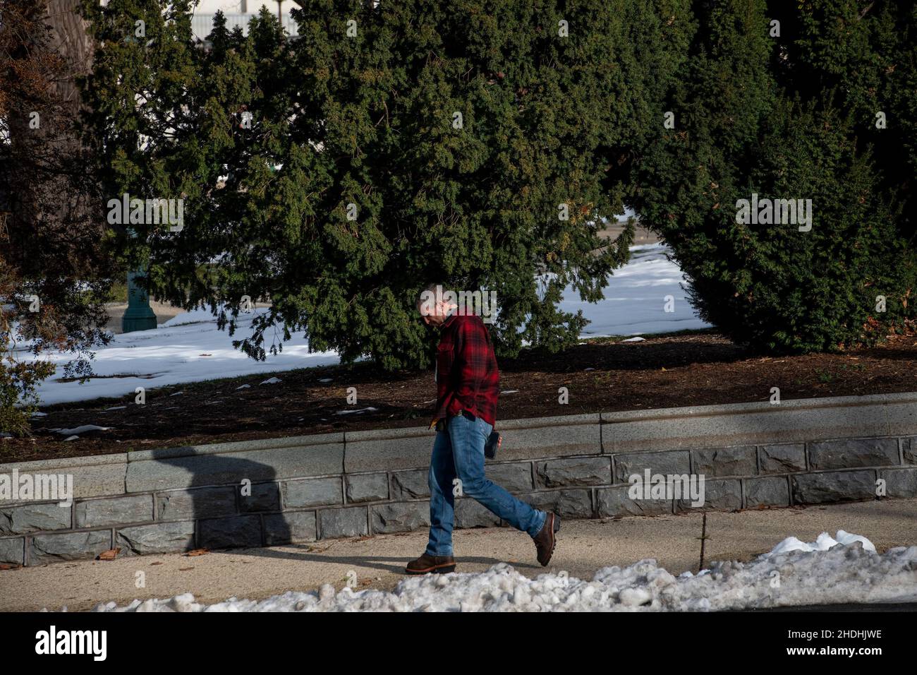 Former Washington DC Metro police officer Michael Fanone walks alone along Independence Avenue SE and passes by the US Capitol in Washington, DC, Thursday, January 6, 2022. Today is the one-year anniversary of the January 6 insurrection at the US Capitol. Credit: Rod Lamkey/CNP Stock Photo