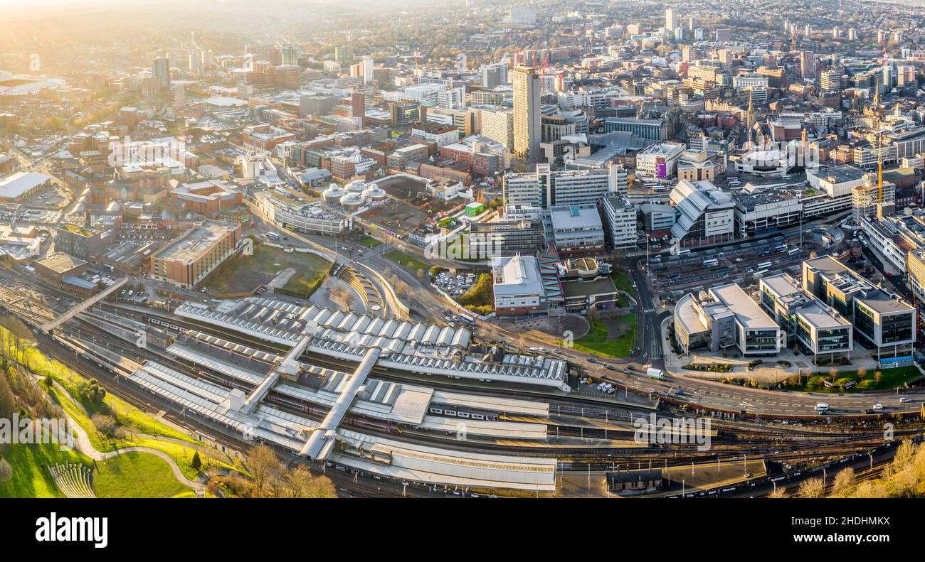 SHEFFIELD, UK - DECEMBER 16, 2021. Aerial view of Sheffield city centre cityscape with Sheffield railway and tram station from above Stock Photo