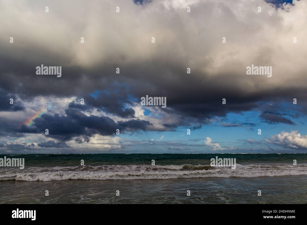 Rainbow and clouds at a sea Stock Photo - Alamy