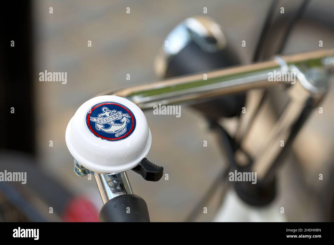 Ship anchor bicycle bell .Bicycle handlebar with bell with blurred background. Stock Photo