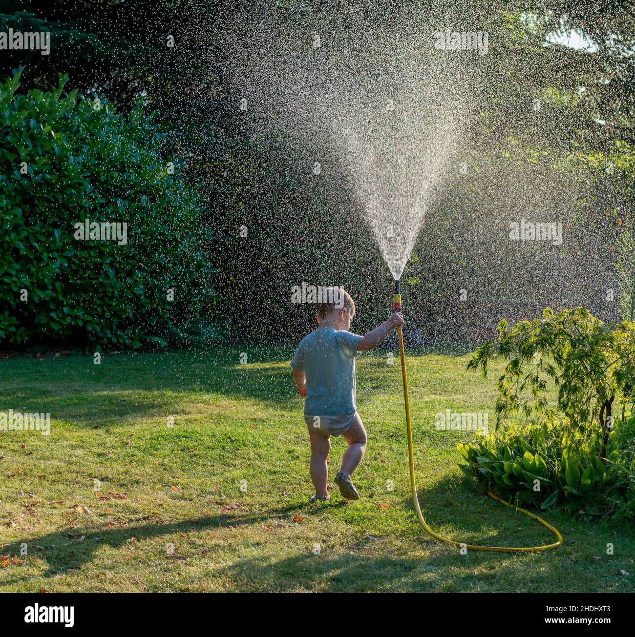 toddler, cooling, garden hose, infant, infants, toddlers, garden hoses Stock Photo