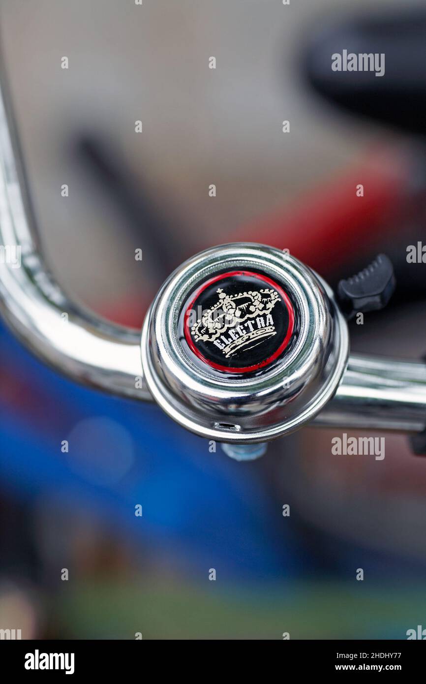 Crown bicycle bell .Retro style bicycle hand-grip with ancient ring bell with blurred  background. Stock Photo