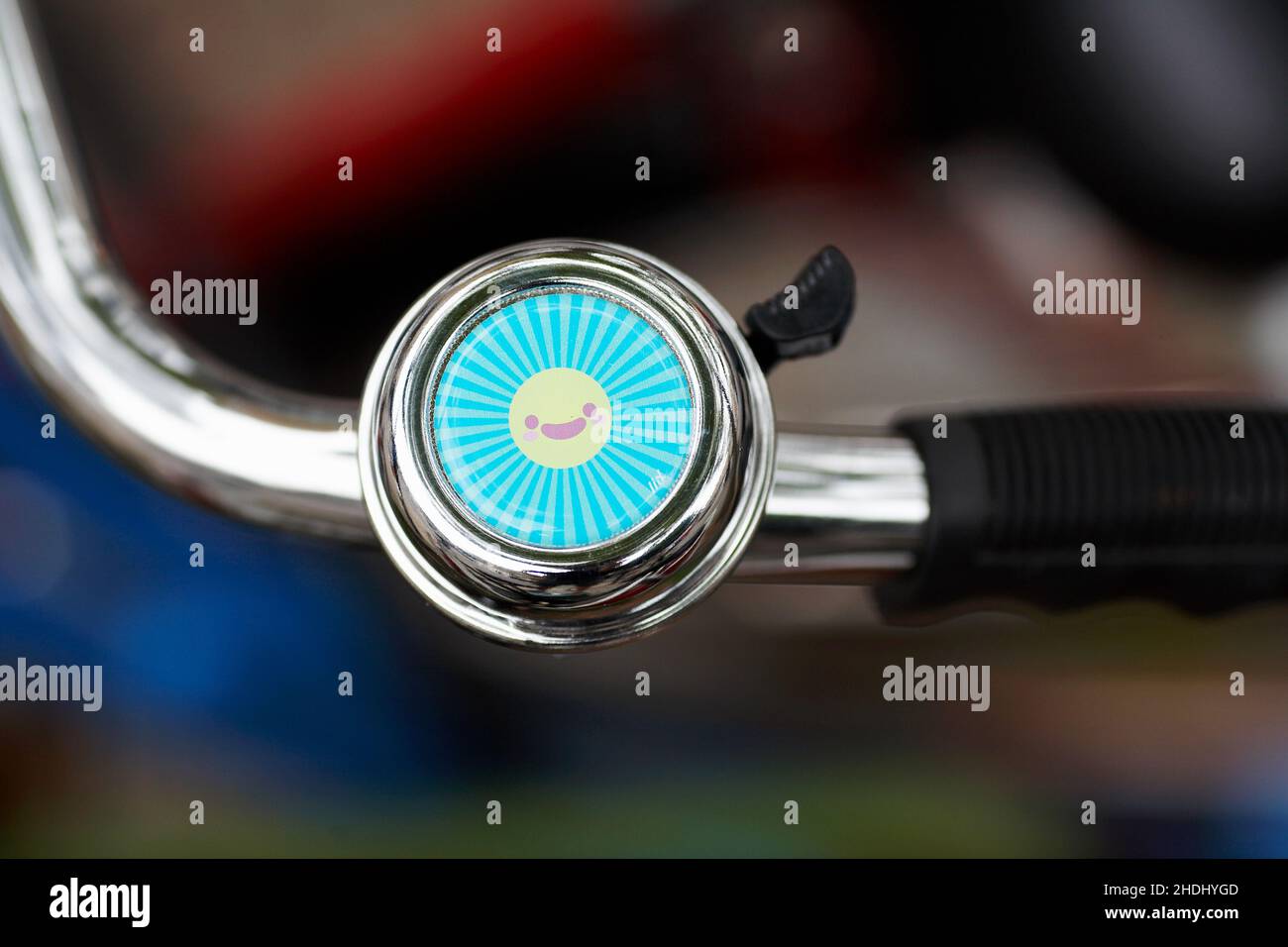 Bicycle handlebar with bell with blurred background. Stock Photo