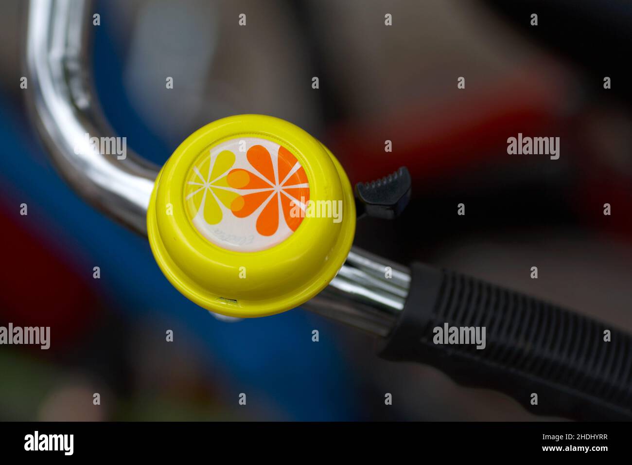 Flower bike bell .Bicycle handlebar with bell with blurred background