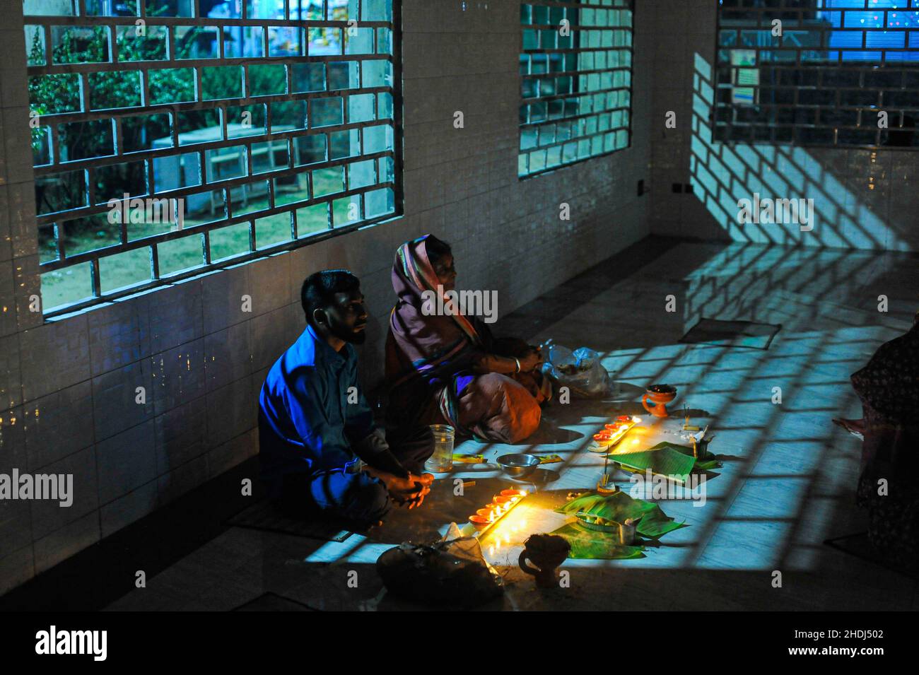 Karakerkar Ritual Devotees offer prayers during the ritual called Kartik Brati or Rakher ...