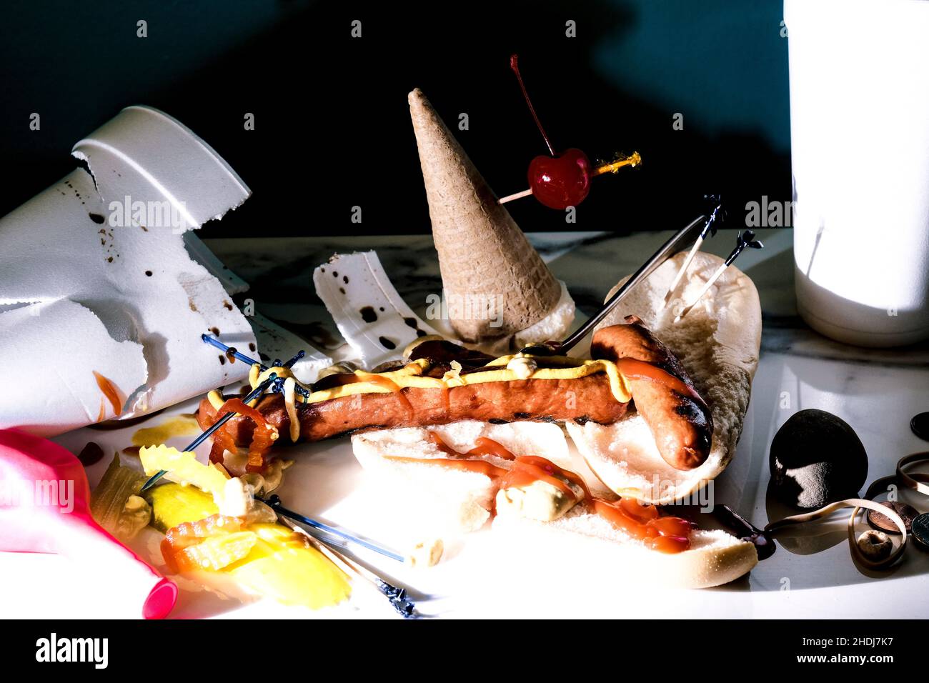 Hot dog and icecream cone mess after fun barbecue party Stock Photo