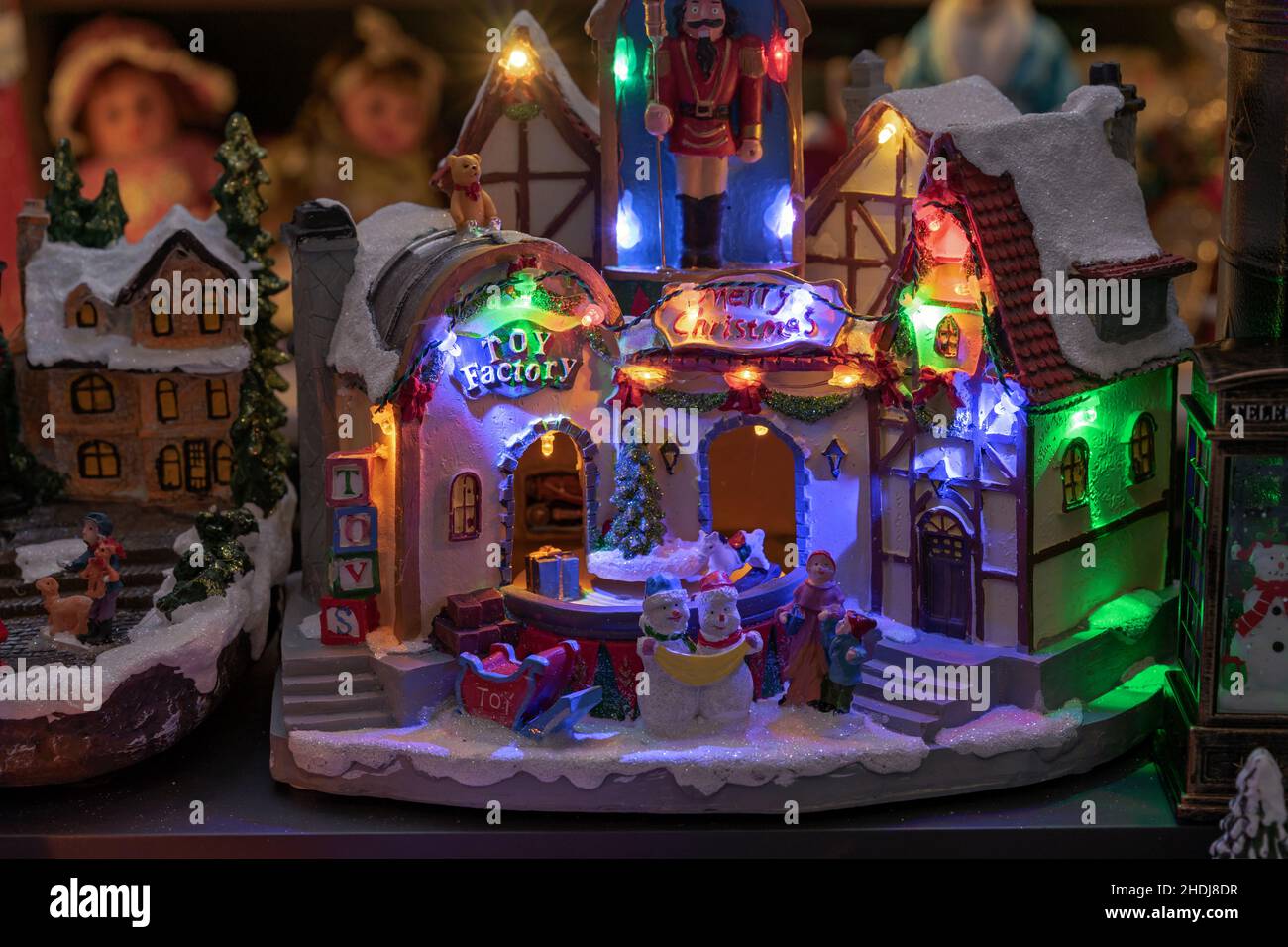 Toy Christmas village with colorful illumination and moving figures ...
