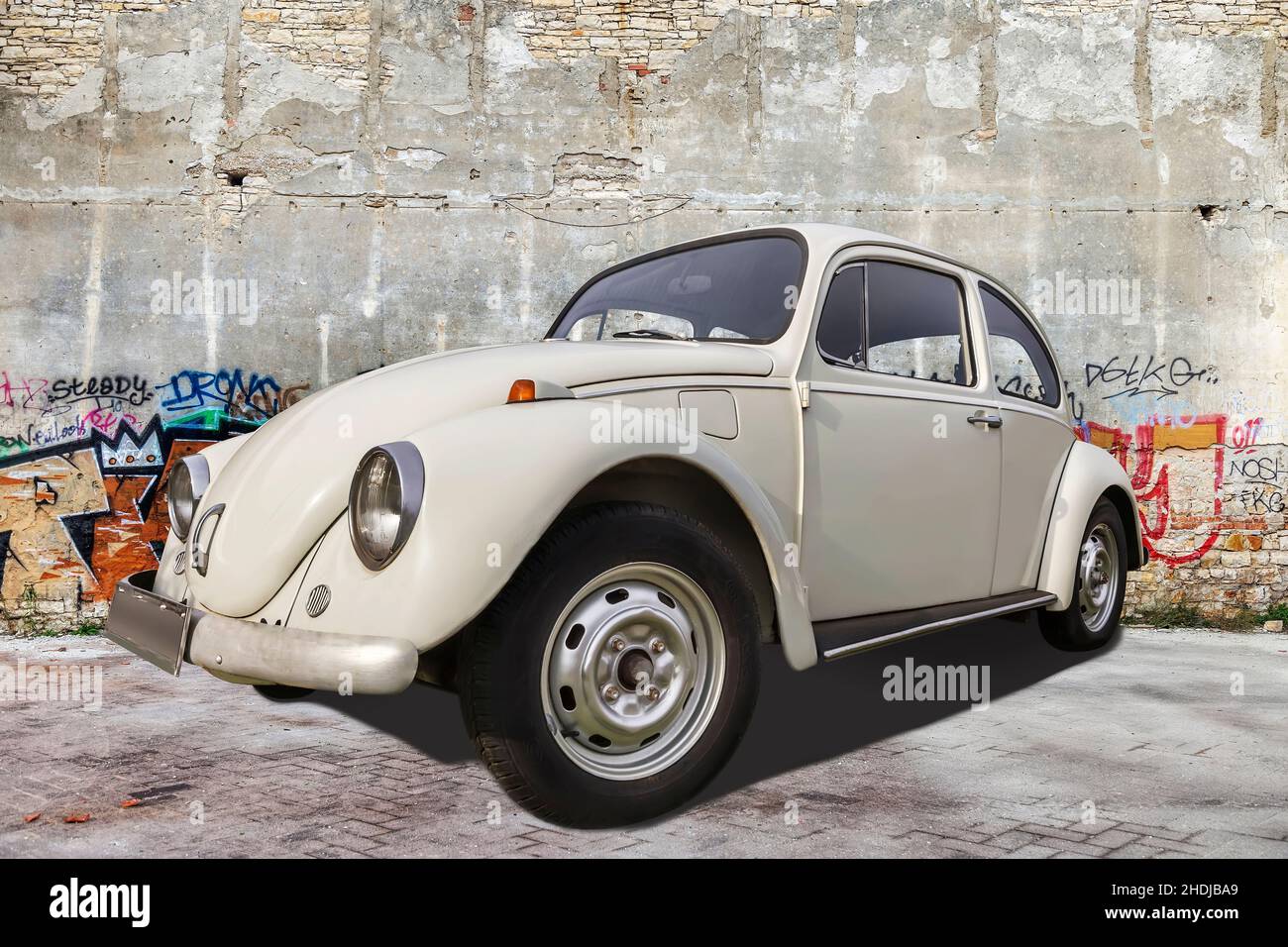 PULA, CROATIA - DECEMBER 12, 2016: VW beetle old-timer car parked in front of the wall with colorful graffiti, Pula, Istria, Croatia Stock Photo