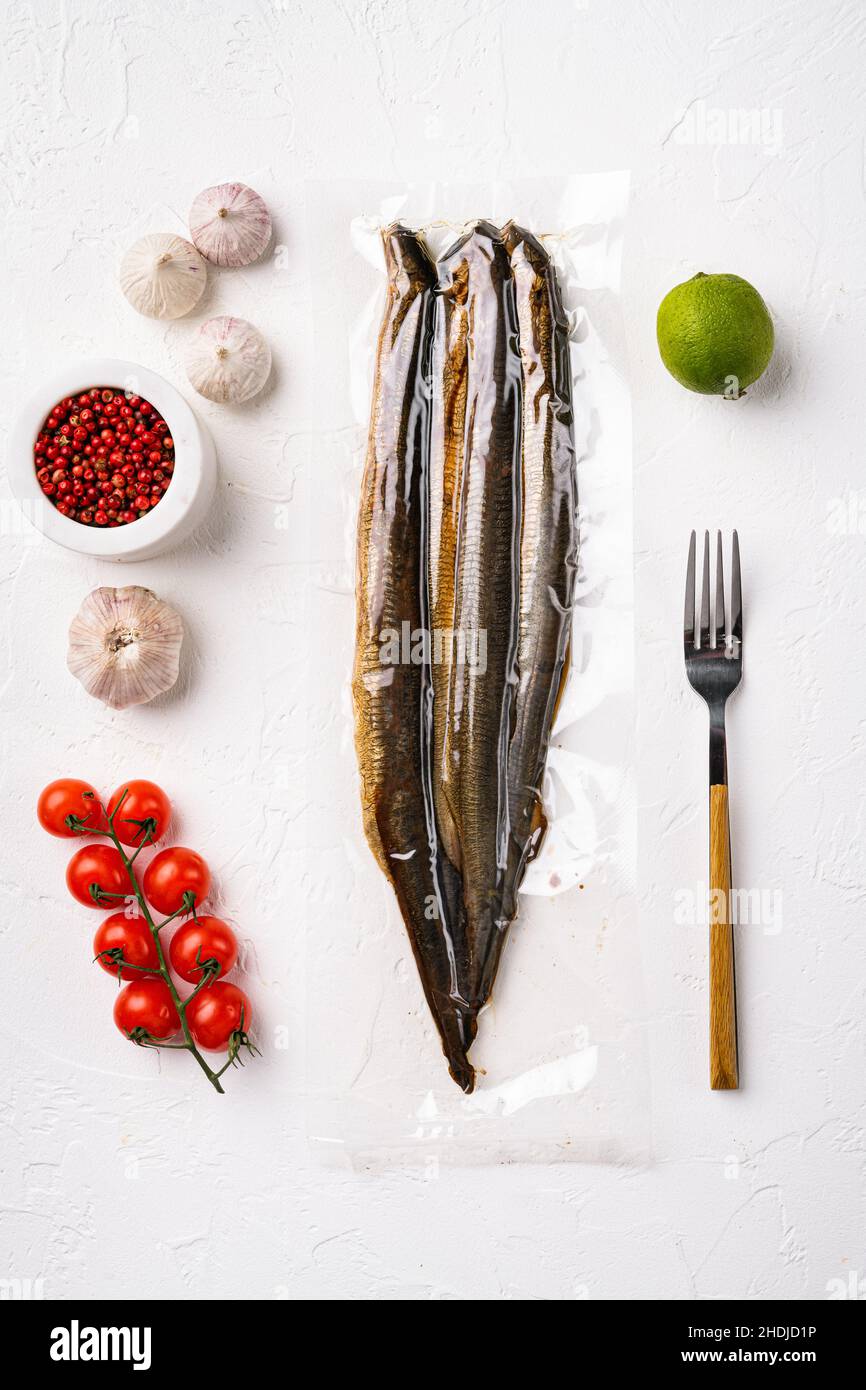 Smoked Lamprey seafood delicacy vacuum pack set, on white stone table ...