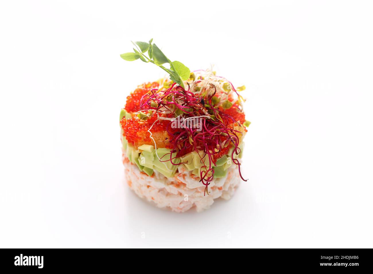 Chopped crab tartare with caviar and avocado. Fresh chopped fish salad. Traditional Japanese dish on a white background. Stock Photo
