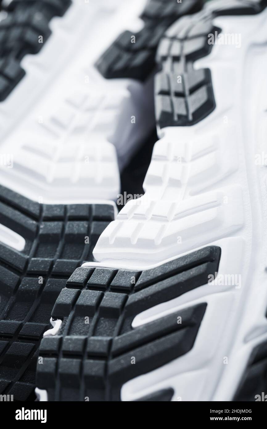The black and white sole of trendy sports sneakers is a closeup in