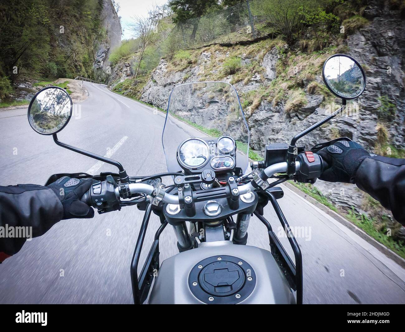 Hitting the road through a canyon with a classic and fast motorcycle Stock Photo
