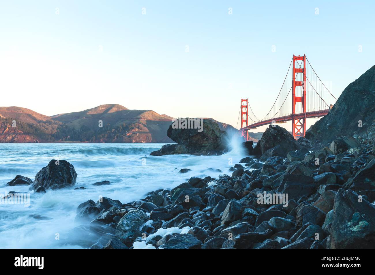 View of the Golden Gate Bridge from Marshall Beach at early dawn at king tide, San Francisco, California, USA. Stock Photo