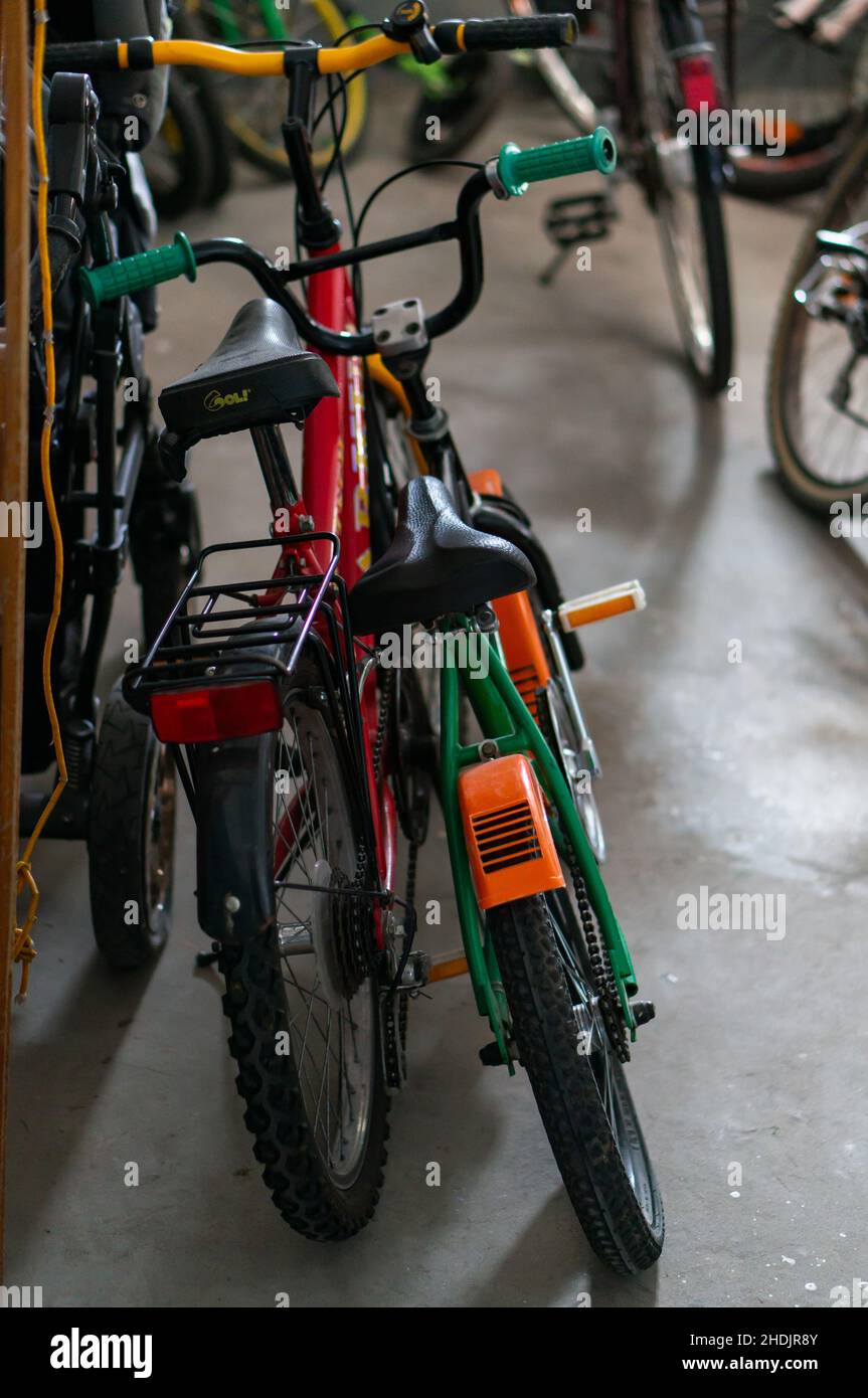 Two parked bicycles for kids in a basement. Stock Photo