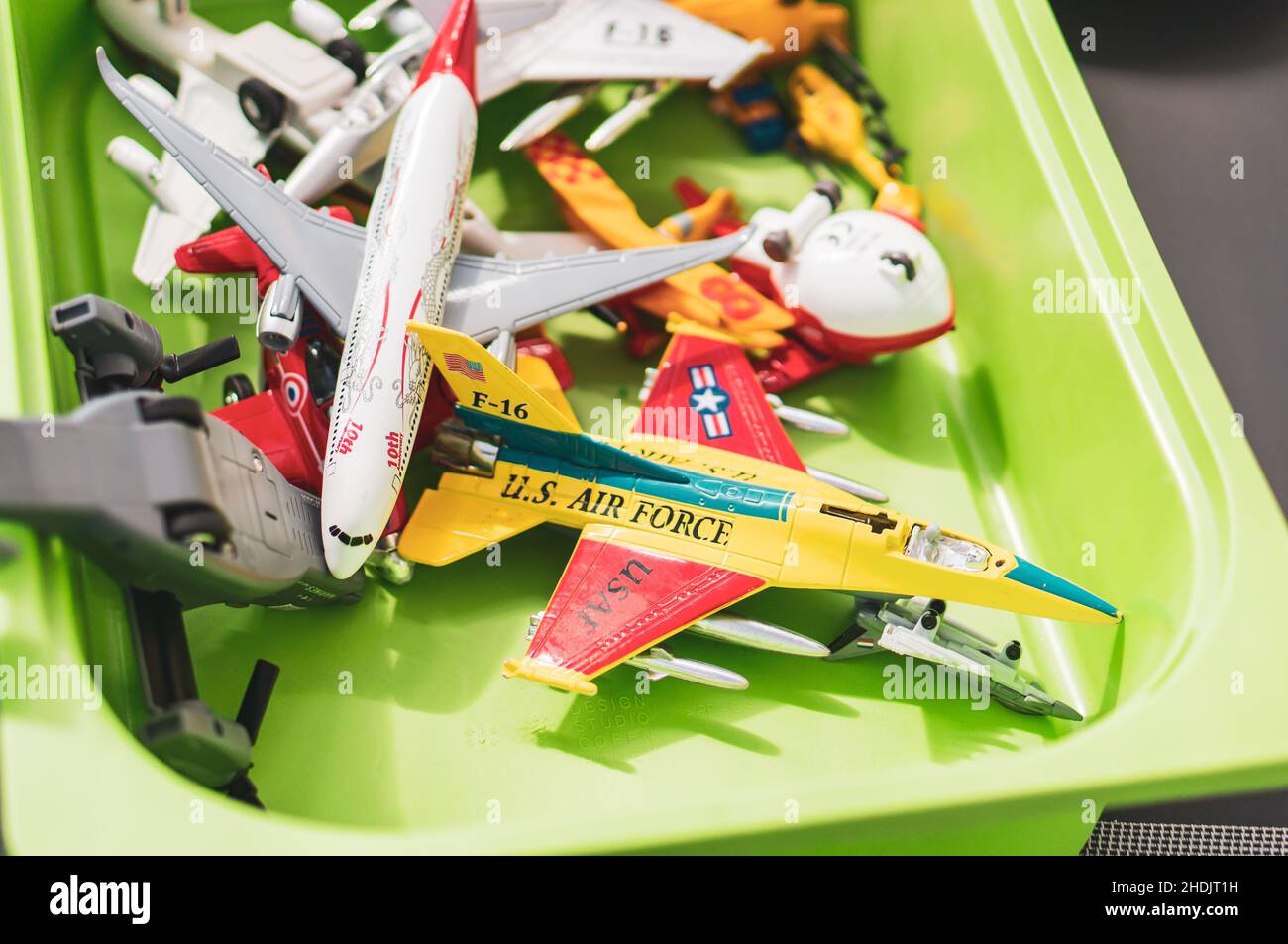 Mix of toy model planes in a green box. Stock Photo