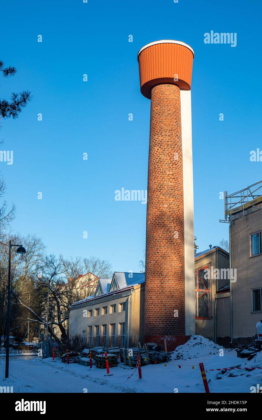 Raisiontien lämpökeskus or Ruskeasuo heating plant chimney stack against clear blue sky in Helsinki, Finland Stock Photo