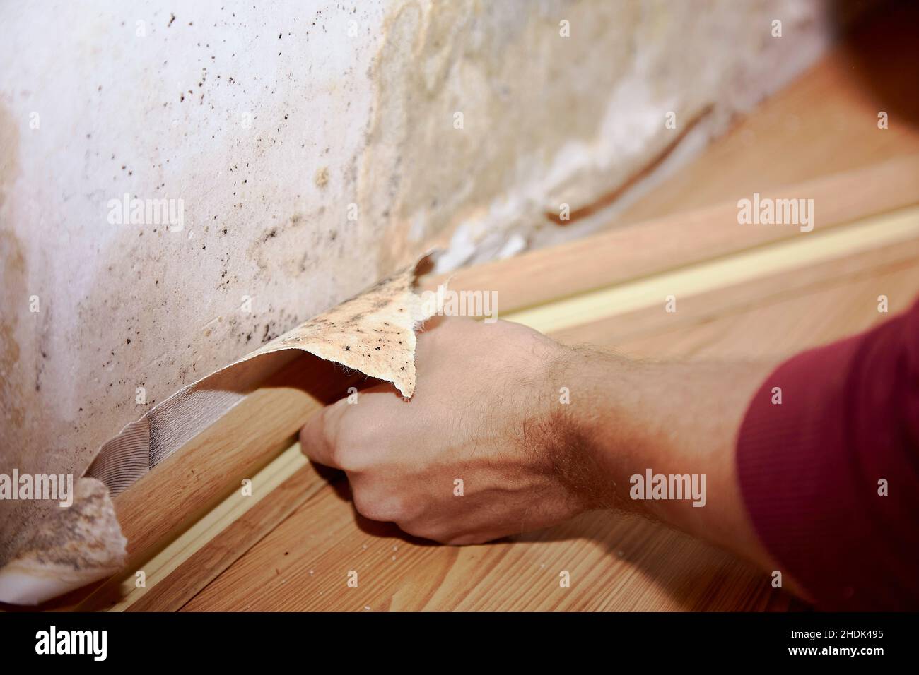Removing the skirting board before removing old wallpaper and painting
