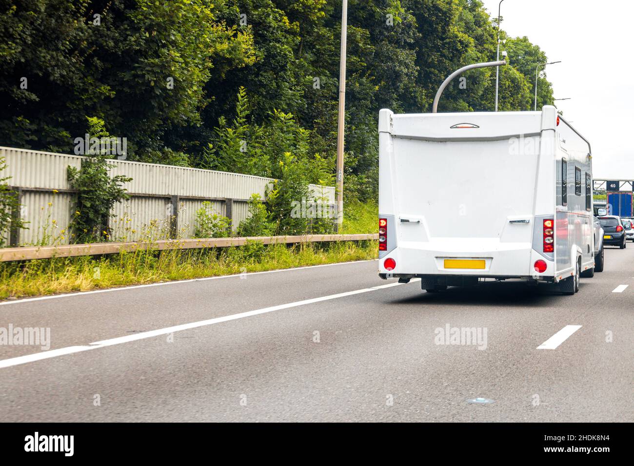 A caravan being towed by another vehicle, on the motorway. A caravan used for a holiday or as a