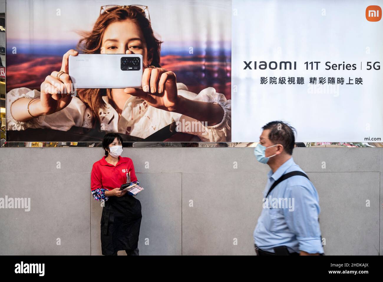Hong Kong, China. 05th Jan, 2022. A pedestrian walks past the Xiaomi Mi